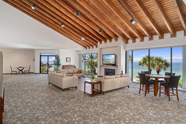 living room with beam ceiling, carpet flooring, high vaulted ceiling, and wooden ceiling