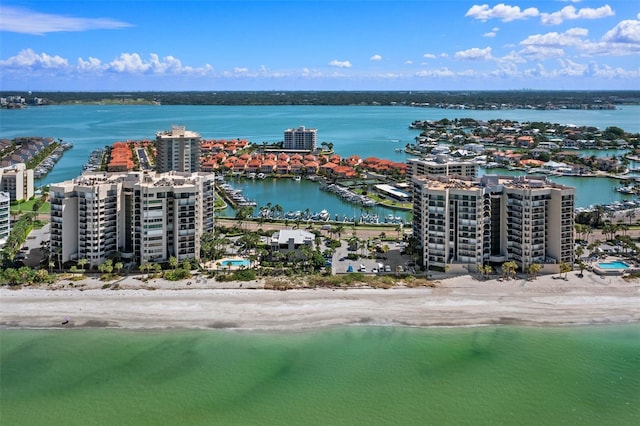 birds eye view of property with a water view and a view of the beach