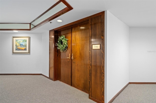 hallway with light colored carpet