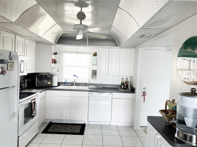 kitchen with white cabinetry, ceiling fan, light tile patterned flooring, and white appliances