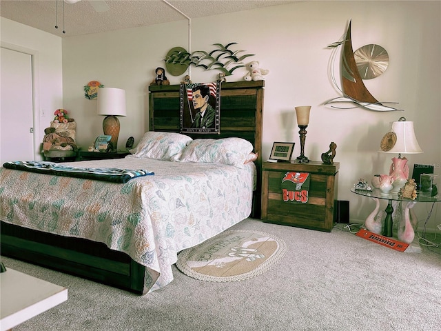 bedroom with carpet, ceiling fan, and a textured ceiling