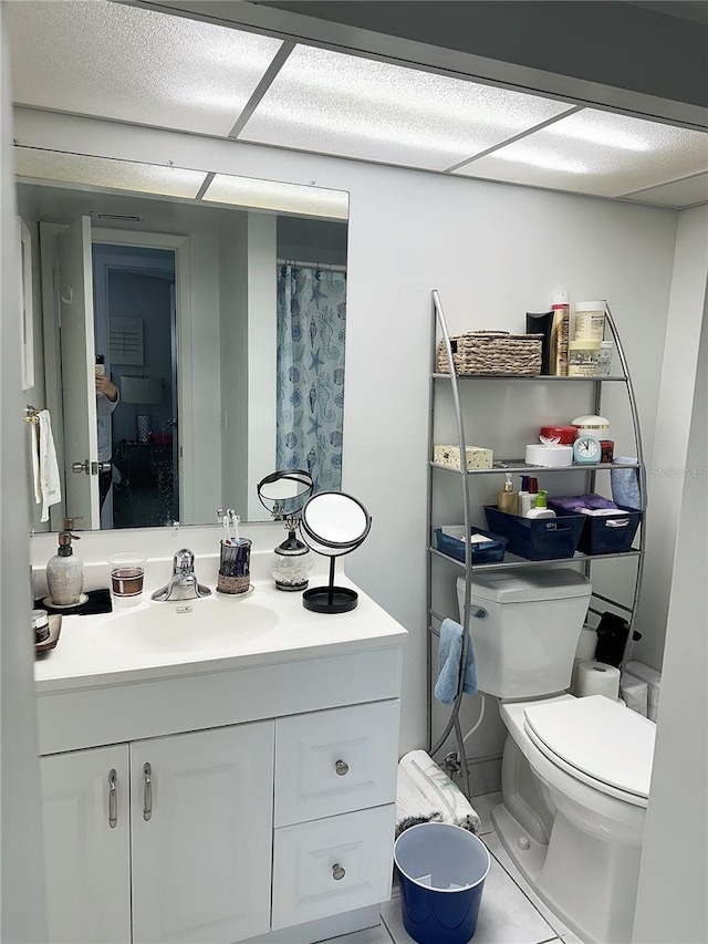 bathroom featuring tile patterned floors, vanity, toilet, and walk in shower