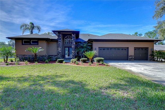 view of front of home featuring a garage, a front lawn, and french doors