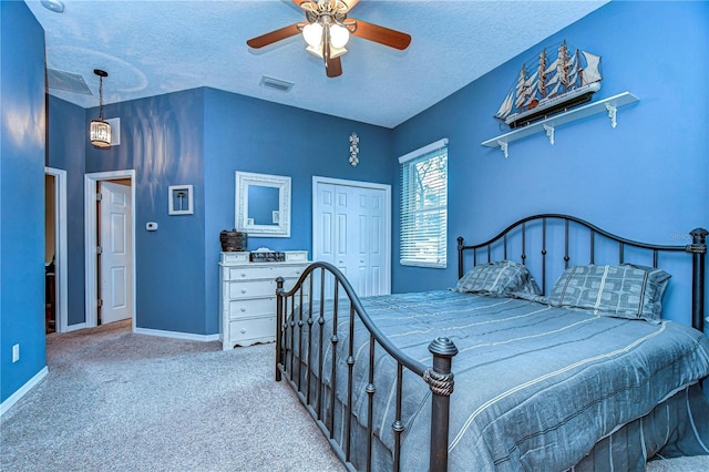 carpeted bedroom featuring a textured ceiling, ceiling fan, and a closet