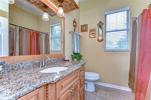 bathroom featuring tile patterned flooring, vanity, and toilet