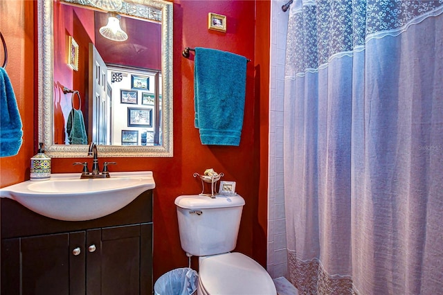 bathroom featuring vanity, toilet, and curtained shower