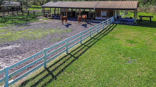 view of yard featuring a rural view and an outbuilding