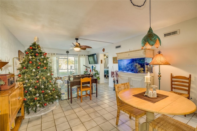 tiled dining room featuring ceiling fan