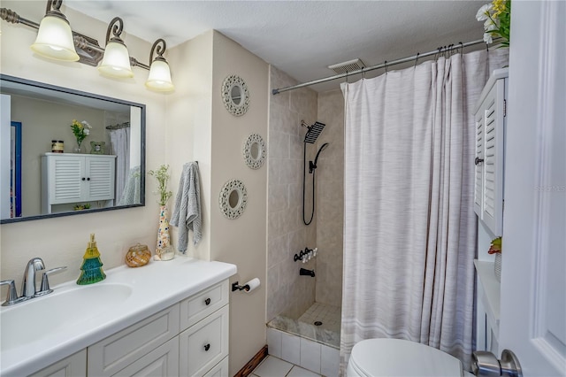 bathroom with vanity, tile patterned floors, a shower with curtain, toilet, and a textured ceiling