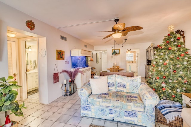 tiled living room with ceiling fan