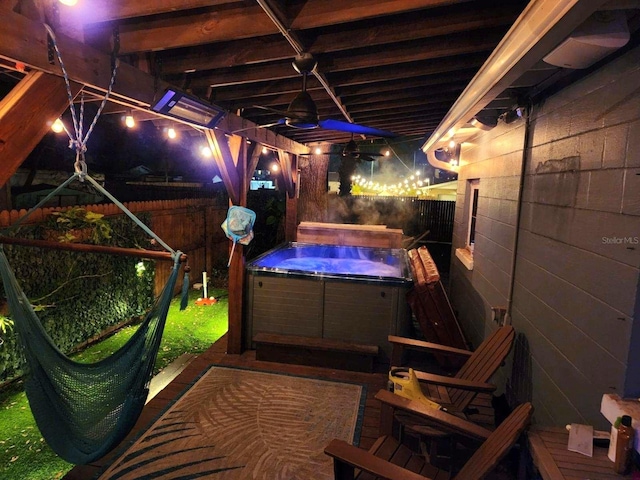 exterior space featuring a hot tub and fence