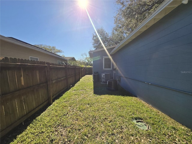 view of yard with cooling unit and fence