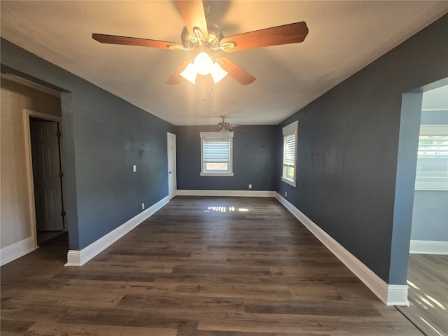 empty room with dark wood-style floors and baseboards