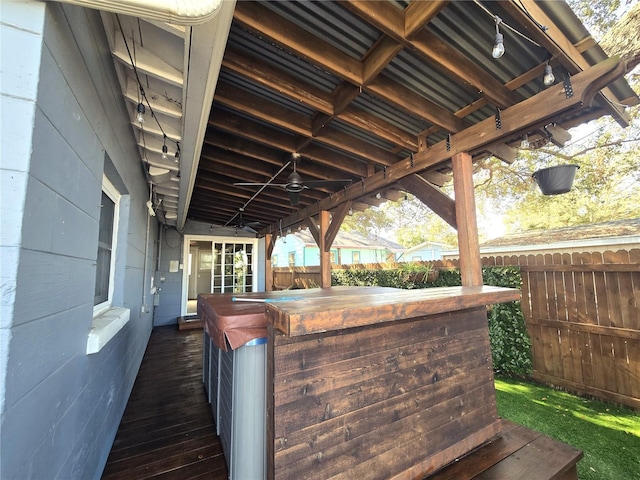 view of patio featuring outdoor dry bar, fence, and a ceiling fan