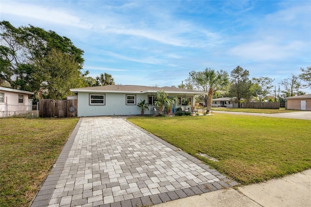 single story home featuring a front lawn