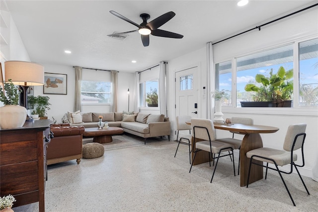 living room with ceiling fan and a healthy amount of sunlight