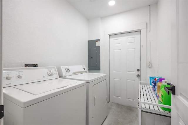 clothes washing area featuring separate washer and dryer and electric panel