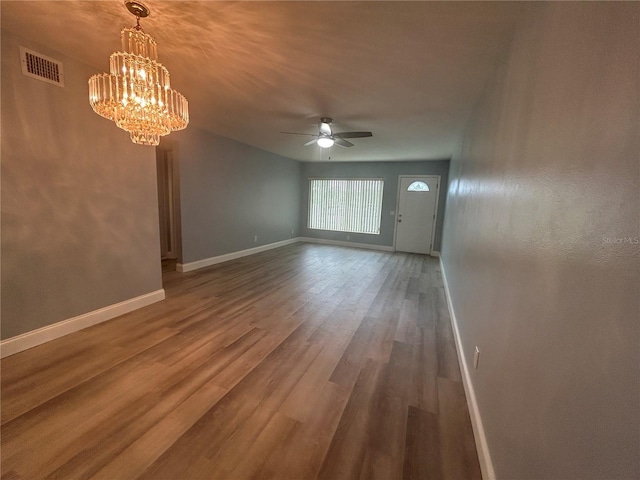 interior space featuring ceiling fan with notable chandelier and wood-type flooring