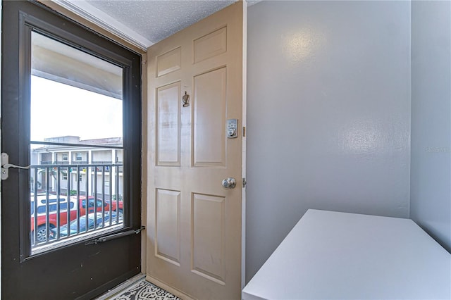 doorway with a textured ceiling