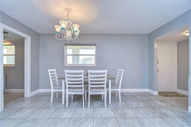 unfurnished dining area featuring a textured ceiling and a notable chandelier