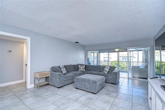 tiled living room featuring a textured ceiling and a wealth of natural light