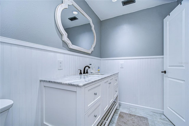 bathroom featuring vanity and toilet