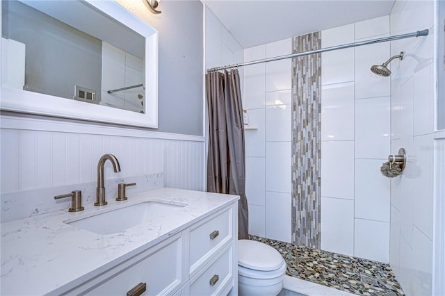 bathroom featuring vanity, toilet, and walk in shower