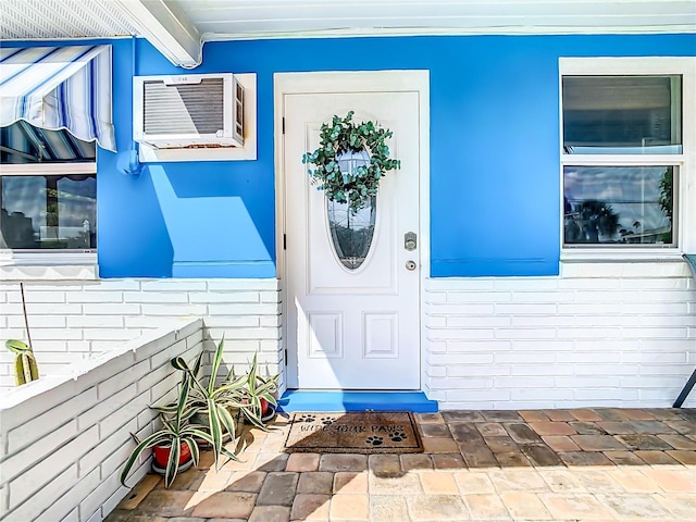 property entrance featuring a wall mounted AC