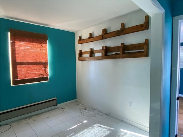 unfurnished room with baseboard heating