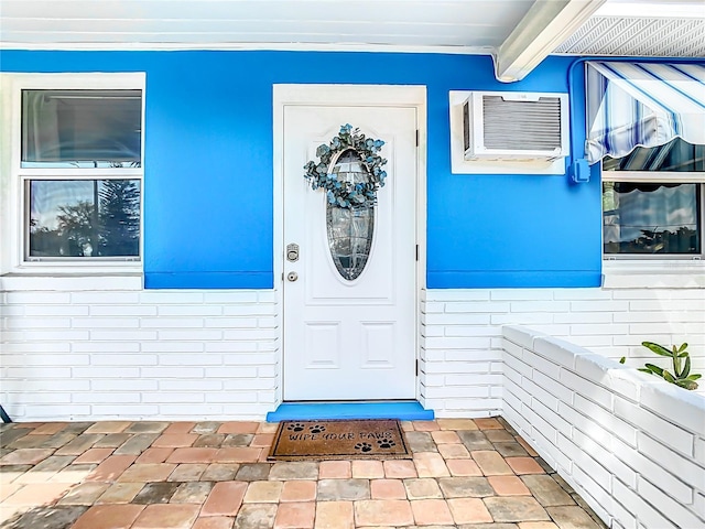 property entrance featuring a wall unit AC