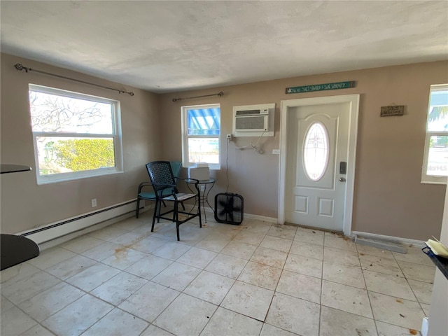 foyer entrance with a wall unit AC and a baseboard radiator