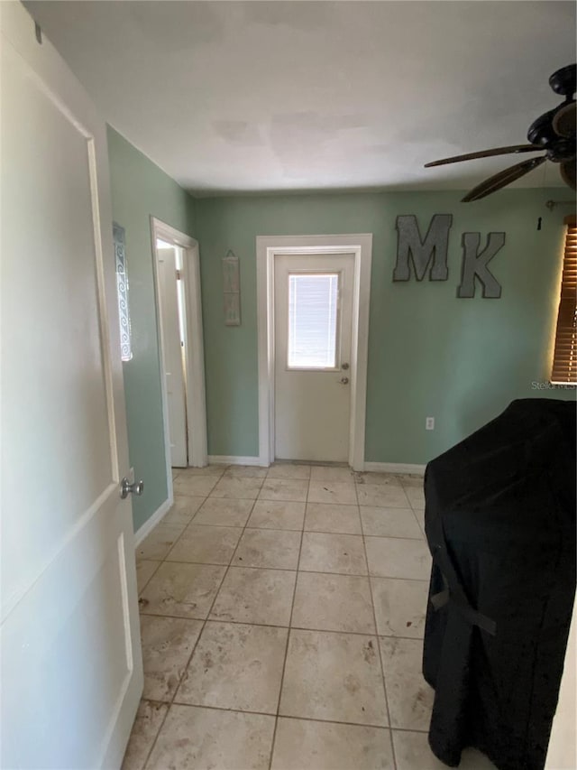 entryway featuring ceiling fan and light tile patterned flooring