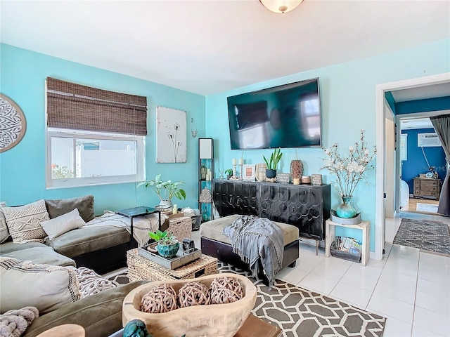 tiled living room featuring a wall unit AC