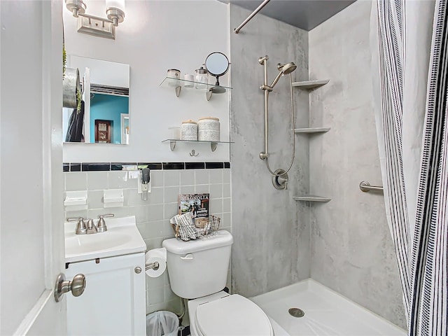 bathroom featuring a shower with shower curtain, vanity, toilet, and tile walls