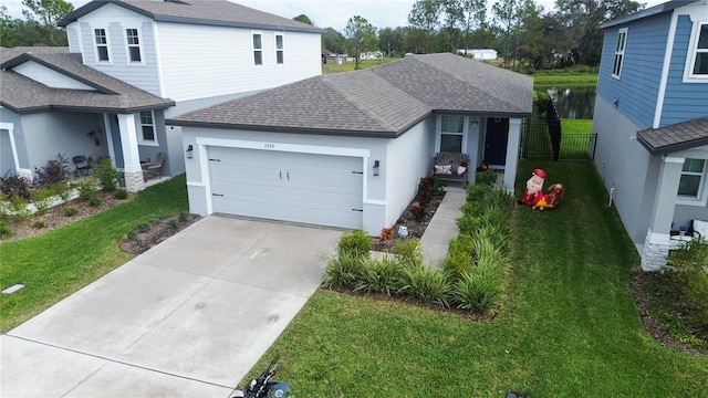 view of front of property with a garage and a front lawn