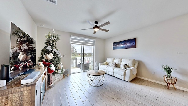 living room featuring ceiling fan and light wood-type flooring