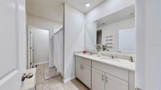 bathroom with a shower with curtain and vanity