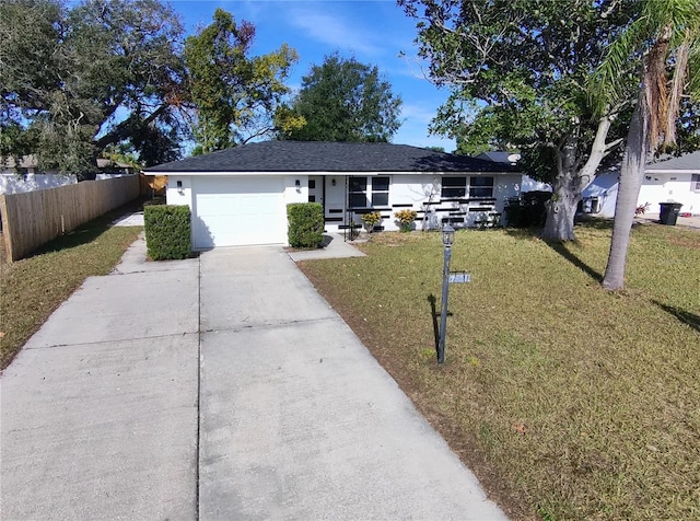 single story home with a garage and a front lawn