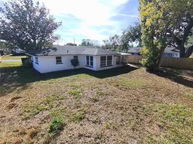 back of property featuring a lawn