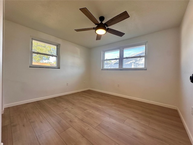 spare room featuring light wood-type flooring and ceiling fan