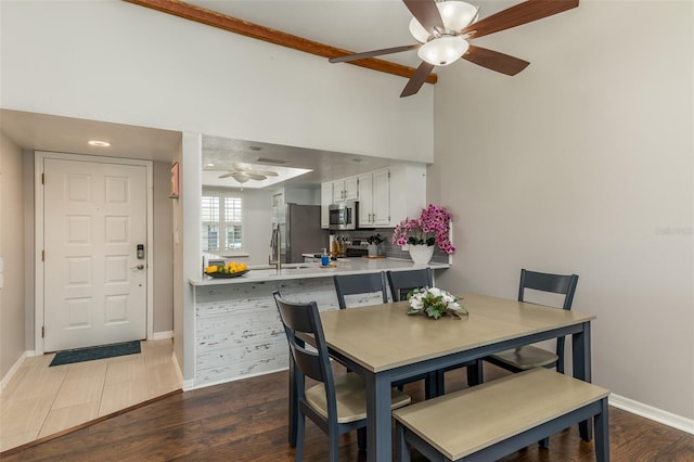 dining room with beamed ceiling, dark hardwood / wood-style floors, ceiling fan, and sink