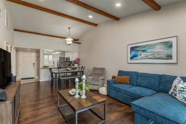 living room featuring lofted ceiling with beams, ceiling fan, and dark wood-type flooring