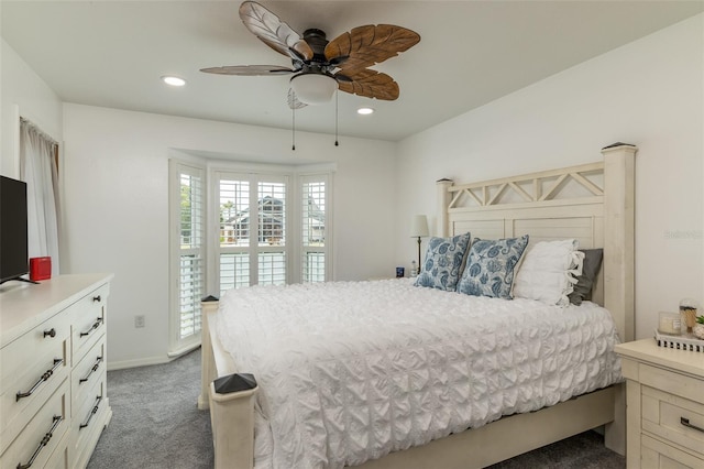 bedroom with ceiling fan and dark carpet