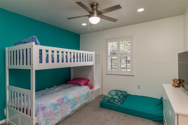 bedroom with ceiling fan and light carpet