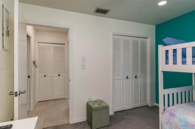 bedroom with a closet and light colored carpet