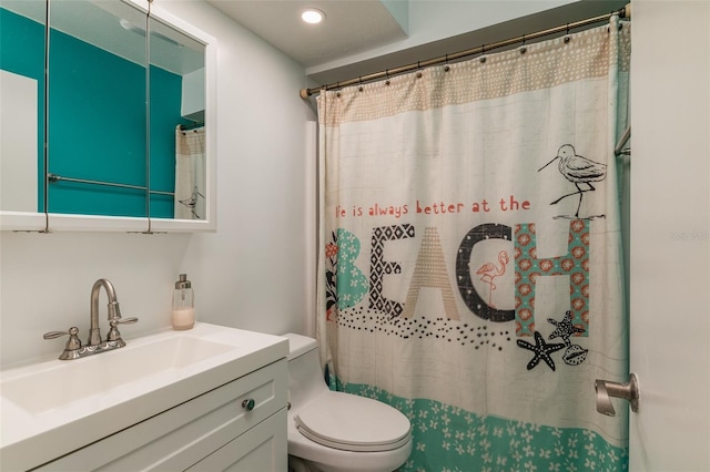 bathroom with vanity, toilet, and walk in shower