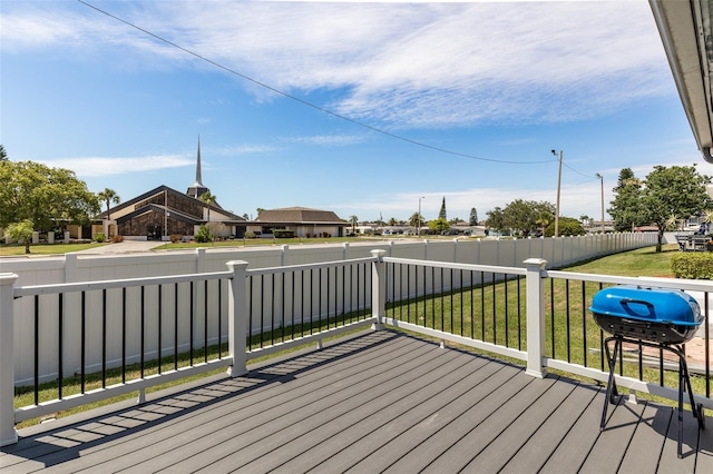 wooden terrace with a yard and grilling area