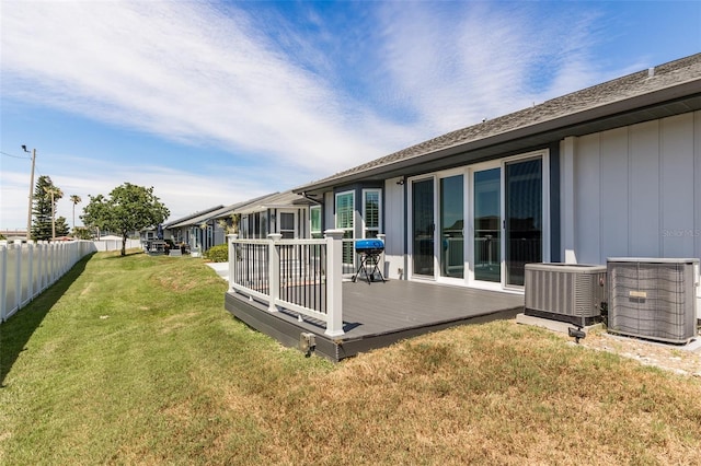 view of yard featuring a wooden deck and central AC