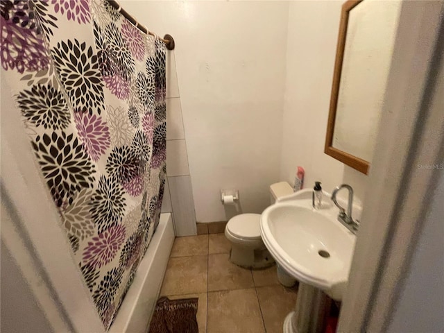 full bathroom with tile patterned flooring, shower / tub combo, toilet, and sink