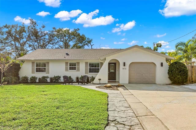 ranch-style house with a garage and a front lawn